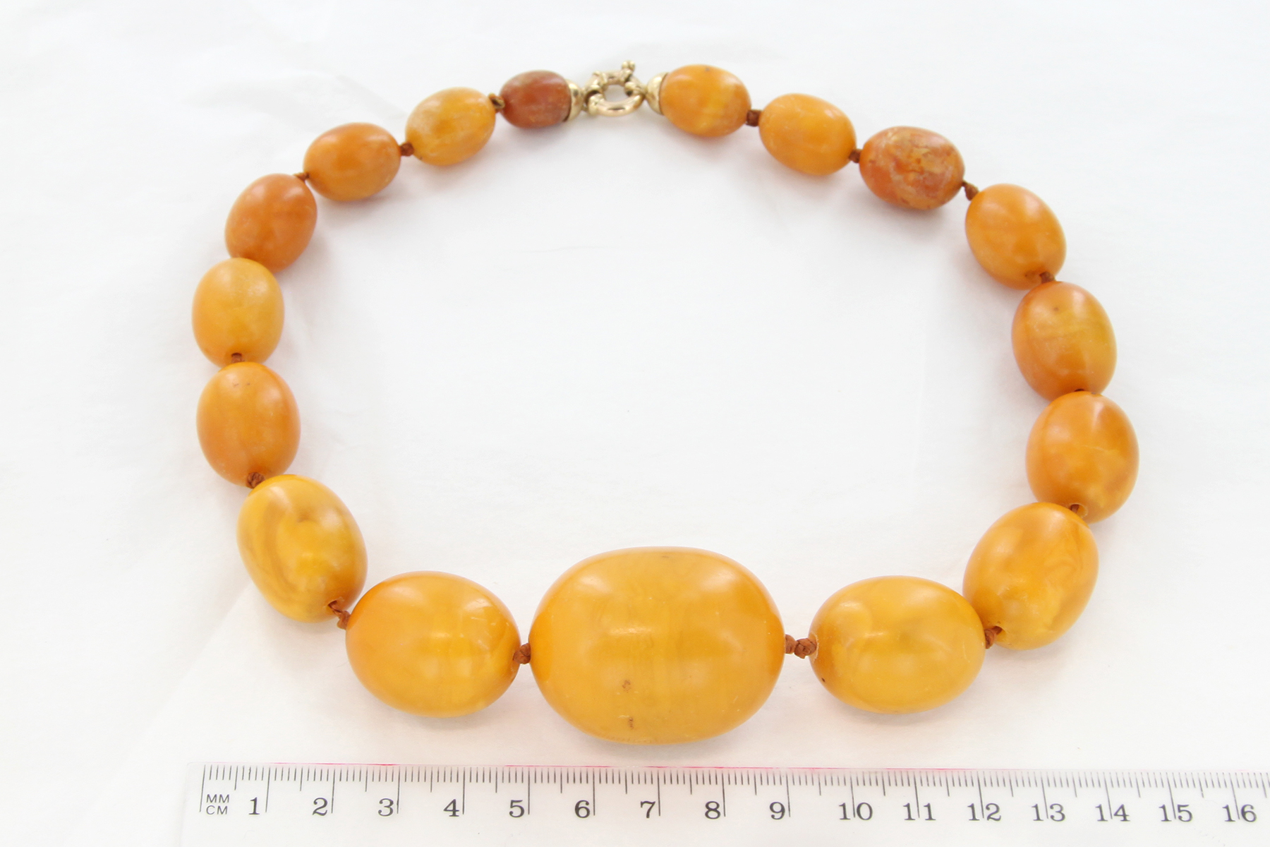 Lot 853 - A butterscotch amber necklace largest bead 2